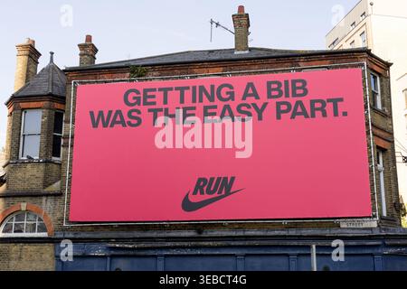 London, UK. 25th April 2026. A Nike "Getting A Bib Was The Easy Part" billboard advertisement on a London building ahead of the 2026 TCS London Marathon, Sunday 27th April 2026. Nike has faced controversy over its marathon billboard campaigns, including the pulling of a "Walkers Tolerated" sign in Boston days earlier and a "Never Again" billboard at the 2025 London Marathon. Represents Nike marathon advertising and outdoor campaign. Credit:xiu bao/Alamy Live News Stock Photo
