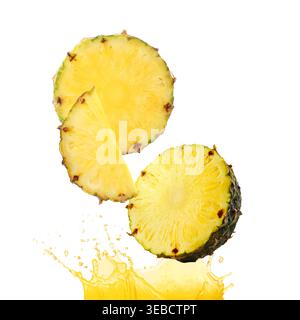 Fresh pineapple pieces falling into splashing juice on white background Stock Photo