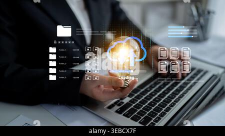 A businessman interacts with a laptop, showcasing cloud technology and data loading visuals. This image embodies modern digital solutions in a Stock Photo