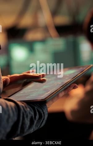 Server illegal access, hacker using malware on digital tablet, computer system password cracking. Cyberattack, internet thieves stealing financial data, coding virus, programming malicious software Stock Photo