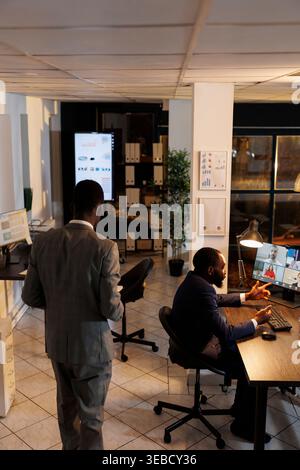 Business team discussing marketing statistics during online videocall meeting conference, working over time at company strategy in startup office. Remote coworkers preparing investment graph Stock Photo