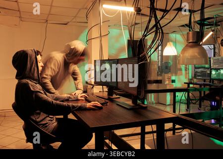Cybercriminals planning network hacking with encryption, breaking into firewall server and stealing sensitive information. Having access to government database after cracking code. Stock Photo