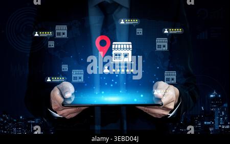 A businessman showcases a tablet displaying a digital map with location pins and ratings, illustrating modern technology impact on customer Stock Photo