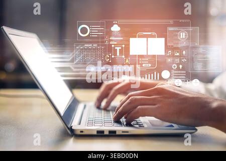 Professional hands typing on a laptop with digital interface showcasing data analytics, graphs, and charts for modern technology and business Stock Photo