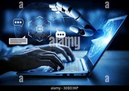 Robotic hand interacts with a laptop screen displaying artificial intelligence icons, symbolizing the future of technology, collaboration, and digital Stock Photo