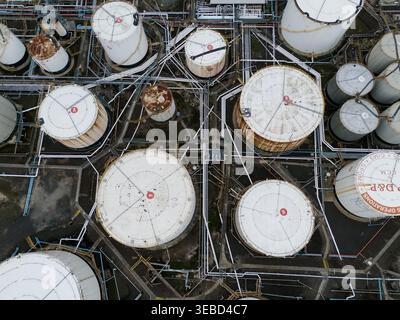 Spotswood, Australia - 01 April 2026: Aerial view of the Yarraville Oil Terminal featuring large white industrial storage tanks connected by a complex Stock Photo