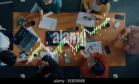 A diverse business team works together in a modern office, analyzing financial data while engaged in discussions and strategic planning to drive Stock Photo