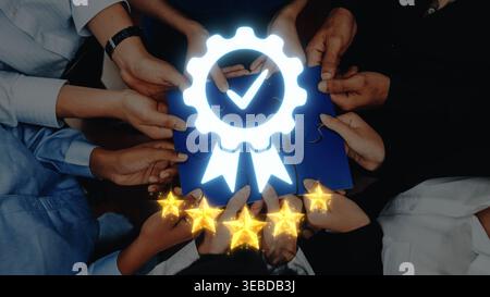 A vibrant collaboration scene featuring diverse hands holding a glowing certificate badge. The image symbolizes recognition, teamwork, and quality in Stock Photo
