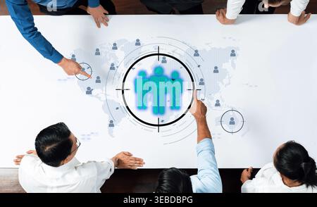 This image captures a dynamic business meeting where professionals engage in strategic planning, utilizing global maps to enhance teamwork and goals Stock Photo