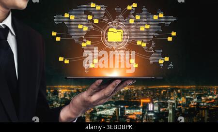 Businessman Holding Tablet with Digital Data Network, Global Connections and Folder Icons Over Cityscape at Night for Technology Concept Fluxor. Stock Photo