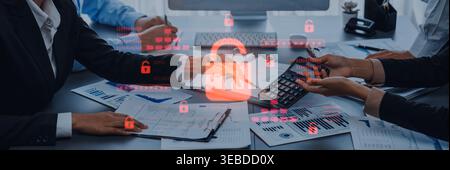 A business team collaborates on financial analysis and data security strategies, highlighting the importance of protection and privacy in modern Stock Photo