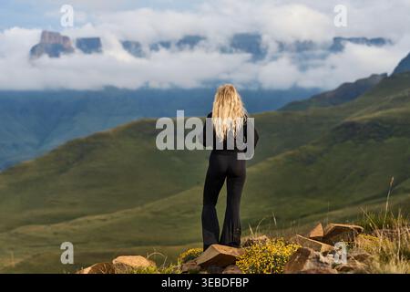 Travel Photographer Capturing Solitary Moment Amidst Misty Hills And Dramatic Cloud Formations Stock Photo