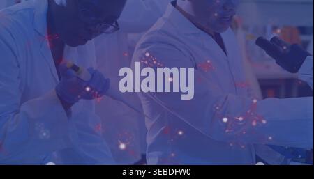 Operating micropipette, two scientists wearing white coats working in lab with microscope overlay Stock Photo