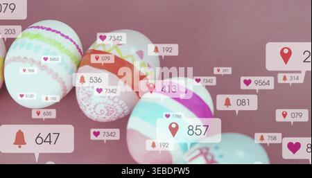 Displaying patterned pastel eggs on mauve tabletop, showing digital notification badges Stock Photo