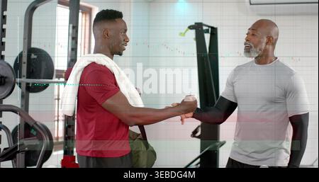 Clasping forearms two men in athletic clothing greeting and talking at gym, with green duffel. Trainingpartner, fitness, teamwork, workout, weights, b Stock Photo