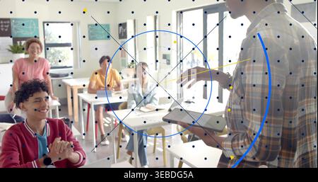 Holding tablet, instructor wearing plaid shirt teaching class in room, digital overlay, copy space Stock Photo