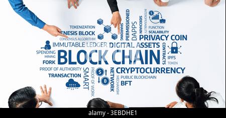 A diverse group of people collaborate over a table, discussing blockchain technologies, digital assets, cryptocurrency innovations, and smart contract Stock Photo