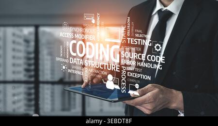 A business professional interacts with a tablet displaying essential coding keywords, emphasizing innovation and the importance of technology in Stock Photo