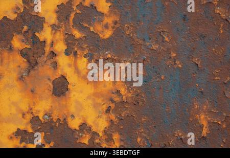 Detailed view of a heavily corroded metal surface featuring peeling layers of rich brown and dark orange rust Stock Photo