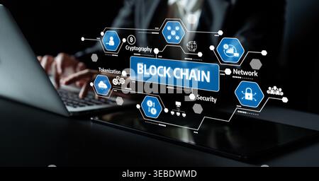 A business professional interacts with a laptop displaying a blockchain technology interface. The image captures key concepts like security, network Stock Photo