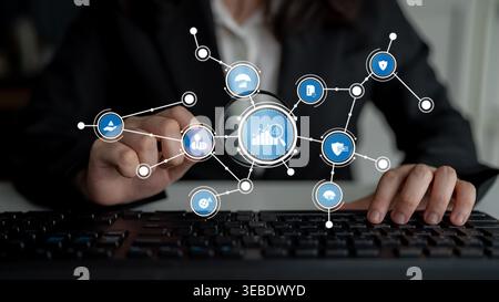 A professional woman interacts with keyboard while engaging with digital icons representing data analytics and technology solutions in a modern Stock Photo