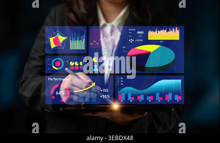 A business professional uses a futuristic touchscreen interface to analyze digital data visualizations, showcasing performance metrics in a modern Stock Photo