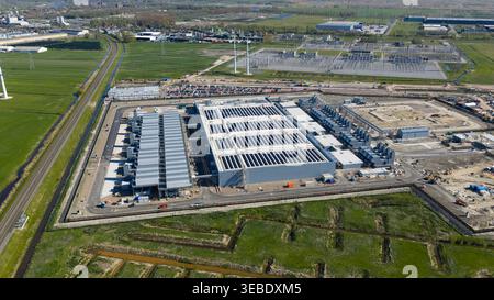 Aerial view of Datacenter Westpoort featuring solar panels on rooftops and surrounding green fields in Groningen, Groningen, Netherlands. Stock Photo