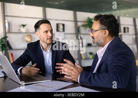 Business colleagues discussing project strategy at office table Stock Photo