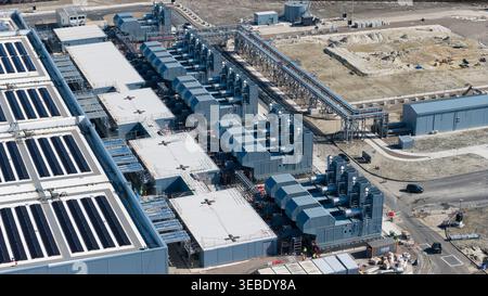 Aerial view of Datacenter Westpoort featuring solar panels on the roof, industrial cooling systems, and complex infrastructure in Groningen, Groningen Stock Photo