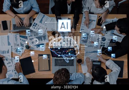 A dynamic business meeting featuring diverse professionals analyzing data, utilizing technology, and collaborating over charts, enhancing decision Stock Photo