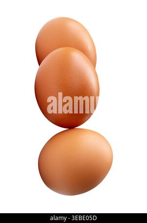 Three raw brown chicken eggs in stack are isolated on white background with clipping path. Stock Photo