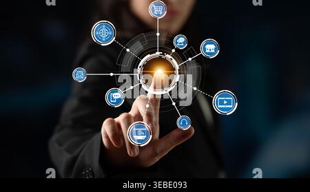 A business professional engages with a digital interface displaying various technology and commerce icons, illustrating interaction and connectivity Stock Photo