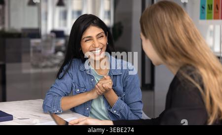 Women colleagues chatting during informal meeting in modern office Stock Photo