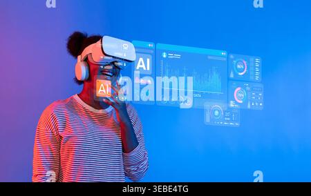 A joyful woman interacts with an immersive virtual reality experience featuring analytics and AI data visualizations against a vibrant blue backdrop Stock Photo