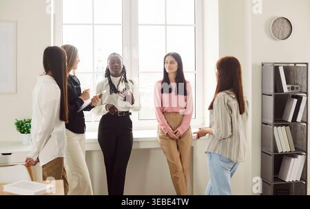 Group of women colleagues having meeting together, discussing business startup Stock Photo