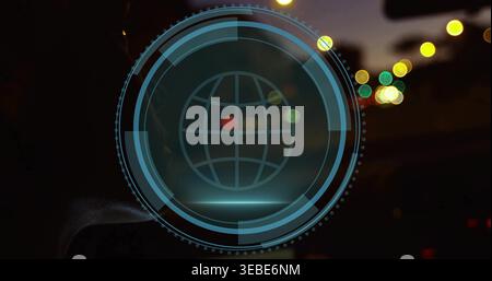 Projecting translucent cyan-blue HUD overlay on windshield at night, with globe icon and bokeh Stock Photo