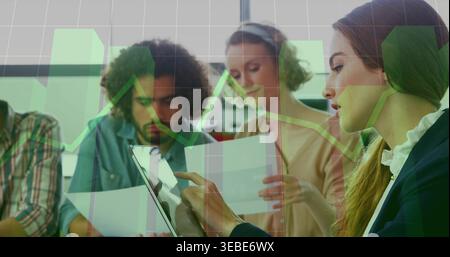 Tapping woman in blazer using tablet at meeting table, team reading papers under charts, copy space Stock Photo