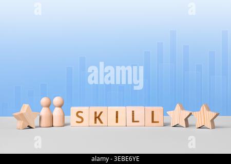 Wooden cubes with the word skill and wooden men on a blue background. Skill competency development concept. Education learning talent, up new ability training technology evolution. Stock Photo
