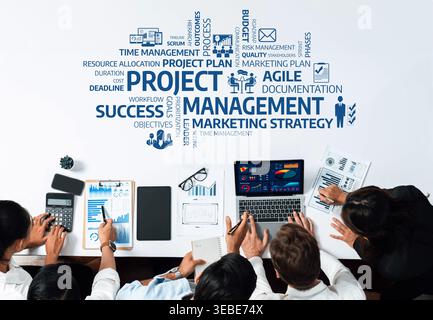 A professional team collaborates on project management strategies, leveraging digital tools and charts for enhanced workflow, productivity, and Stock Photo