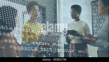 Reviewing code four women working in office with laptops, tablets, glass with code, business-casual Stock Photo