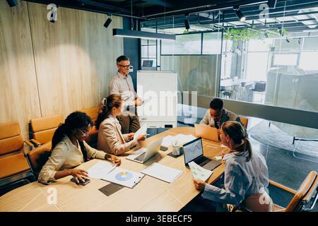 Modern office setting focused on effective project task distribution Stock Photo