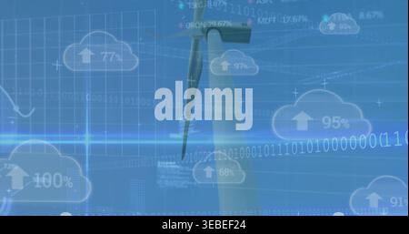 Displaying wind turbine tower and rotor blade merging with cloud data icons over open sky Stock Photo