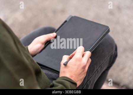 Person using stylus on portable tablet device Stock Photo