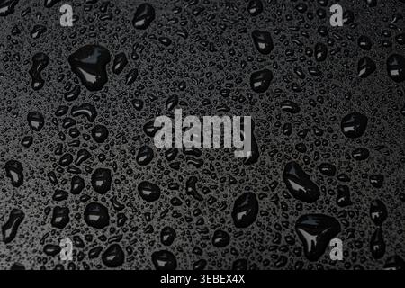 Water Droplets on Black Waterproof Surface Stock Photo