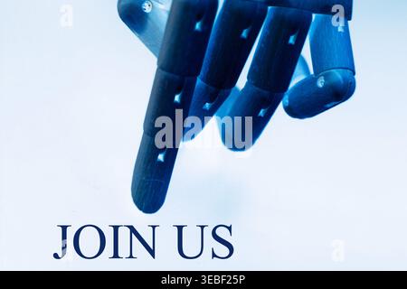 Close-up of a robotic hand pointing toward the text "Join Us", representing recruitment, teamwork, and digital collaboration. Futuristic concept illus Stock Photo