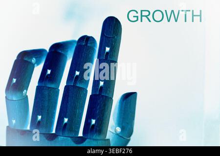 Close-up of a robotic hand with the text "Growth", representing business expansion, digital progress, and technological development. Futuristic concep Stock Photo