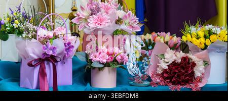 Flowers in decorative boxes arranged on a table for a special event Stock Photo