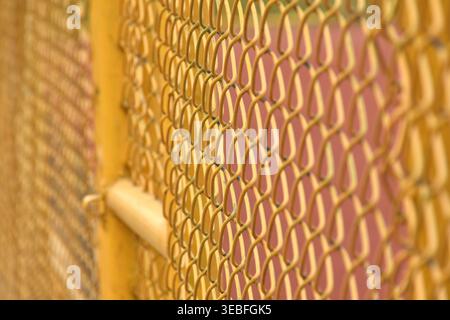 close up of yellow iron door wire net background and texture Stock Photo