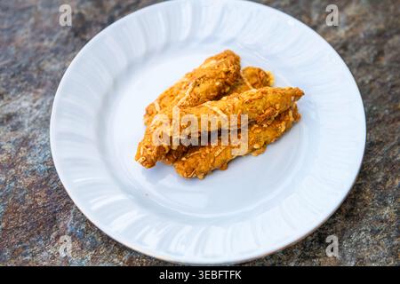 Bread sticks rusk in cheese sesame seeds homemade Greek appetizer food on white home plate on Ikaria island, Greek longevity blue zone macro closeup Stock Photo