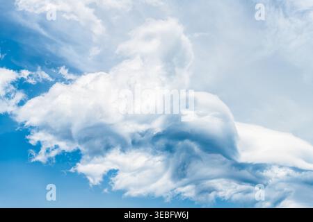Cumulus clouds cloudscape isolated against big white large cloud formations closeup in blue sky skyscape looking up in Ikaria island, Greece Stock Photo